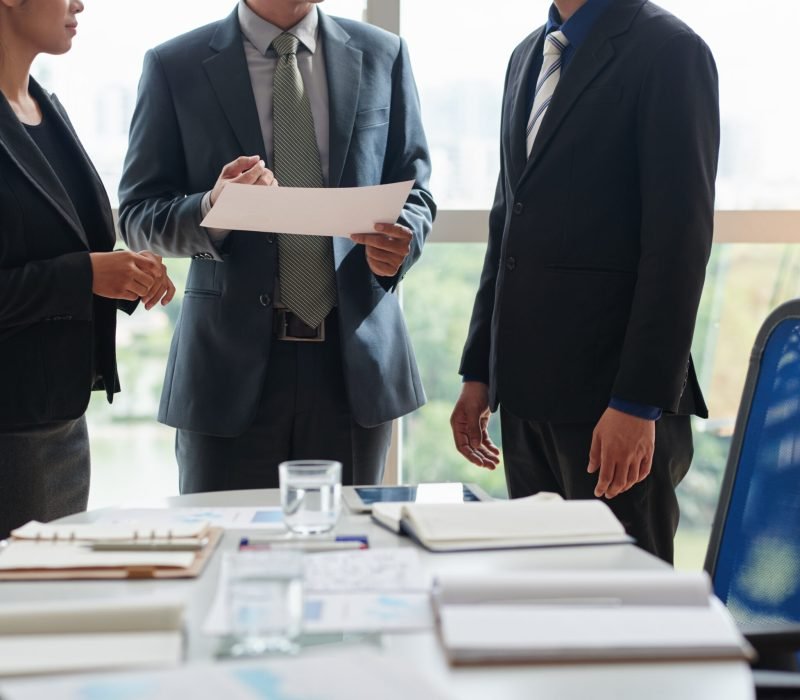Productive Negotiations of Business Partners: entrepreneurs gathered together in spacious boardroom and discussing details of mutually beneficial cooperation