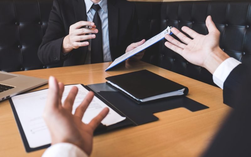 Employer arriving for a job interview, businessman listen to candidate answers explaining about his profile and colloquy dream job, manager sitting in job Interview talking in modern office.